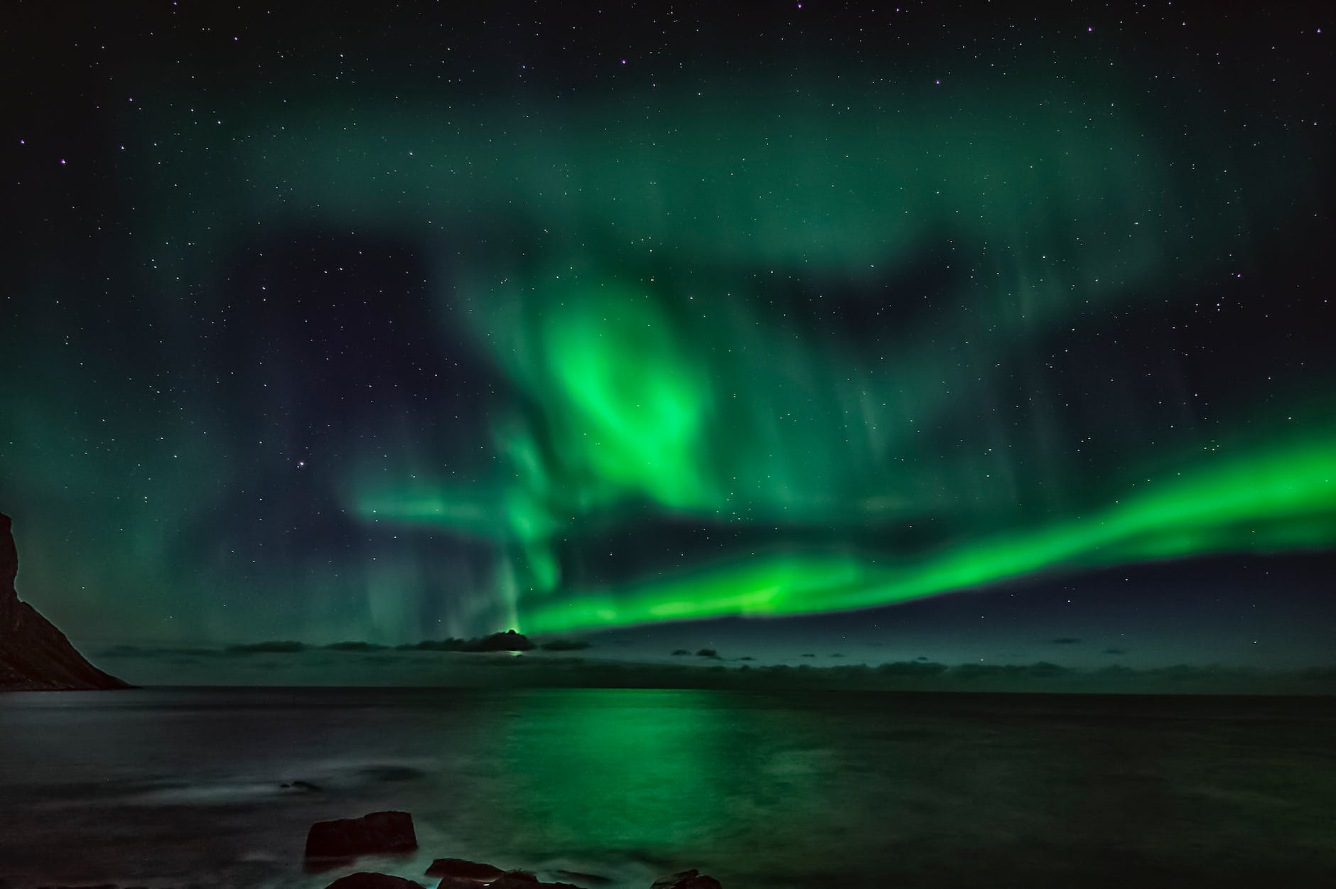 northern lights in starry sky over sea